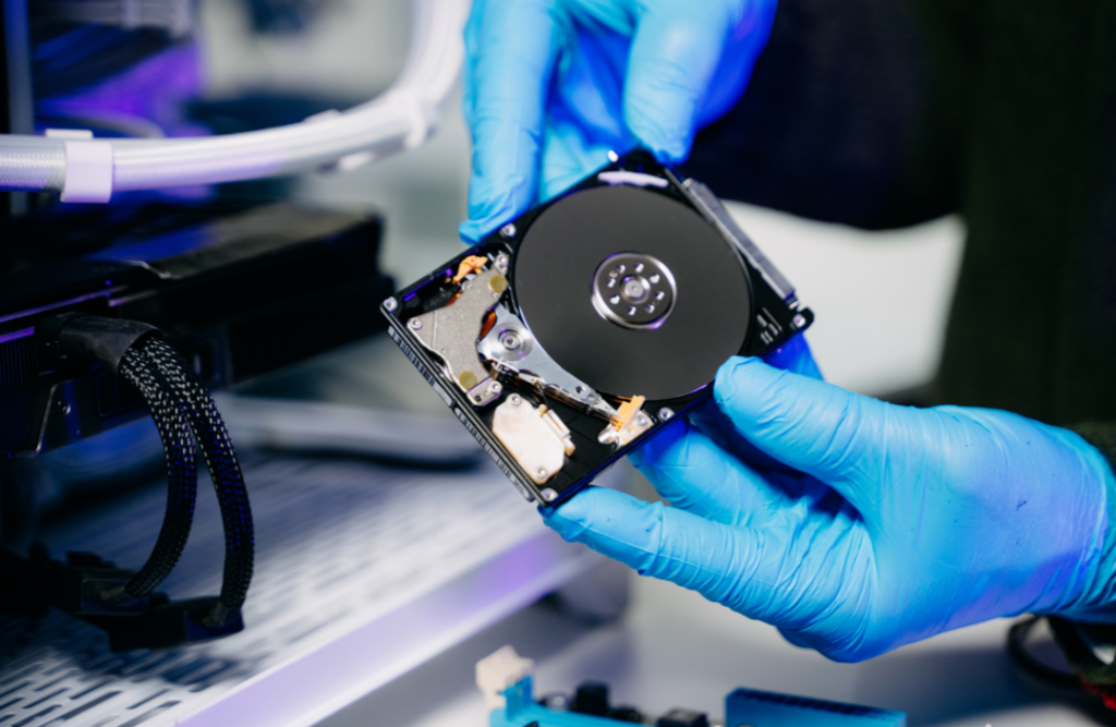 An image showing a technician holding a hardware device—data recovery